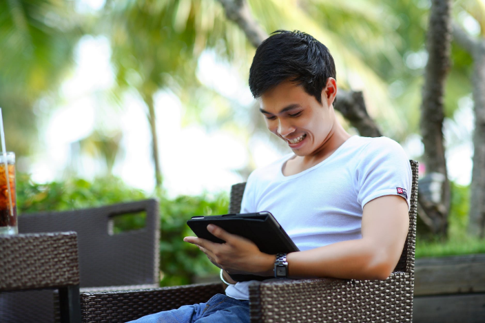 a user smiling while looking at the screen
